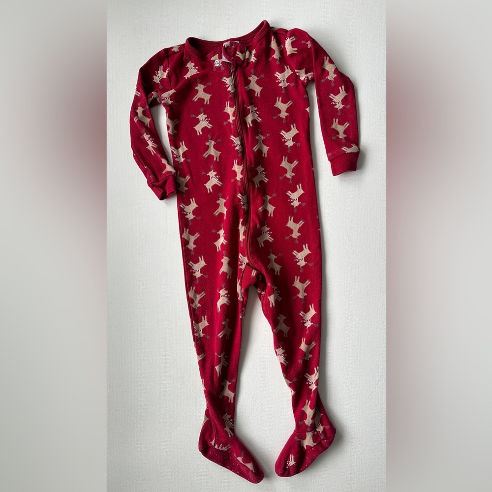 Gymboree girl’s footed pajamas are a red, one-piece sleeper.  Size 18-24M.